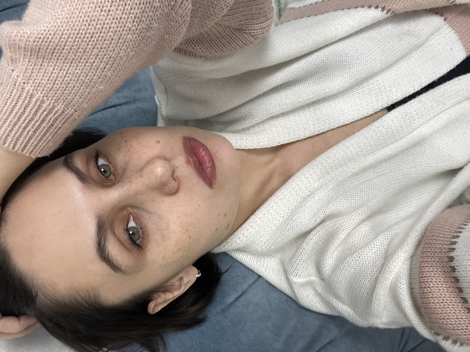 Woman photographed indoors, light snow falls outside in Izhevsk