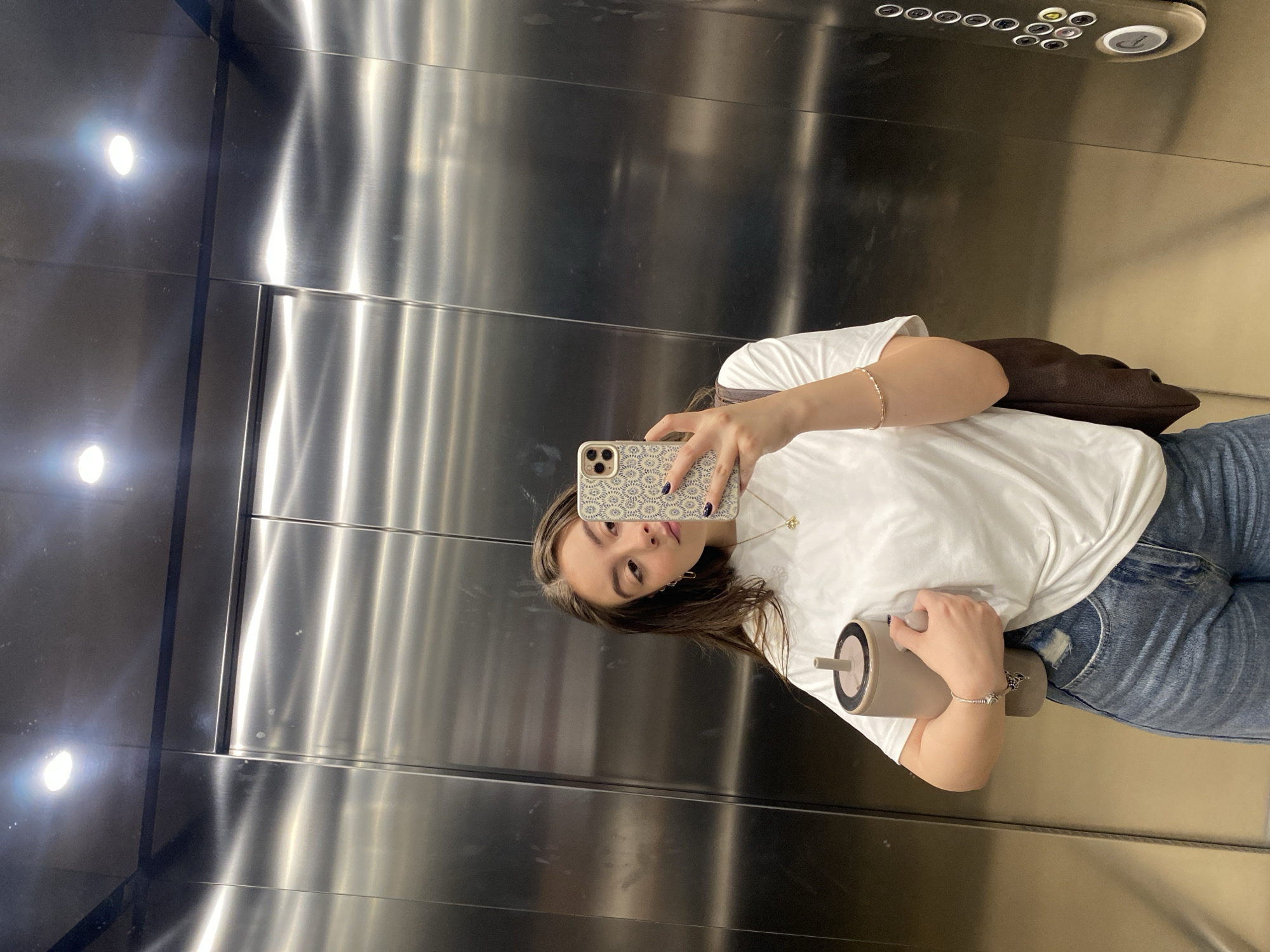 Woman Takes Elevator Selfie at Modern Building