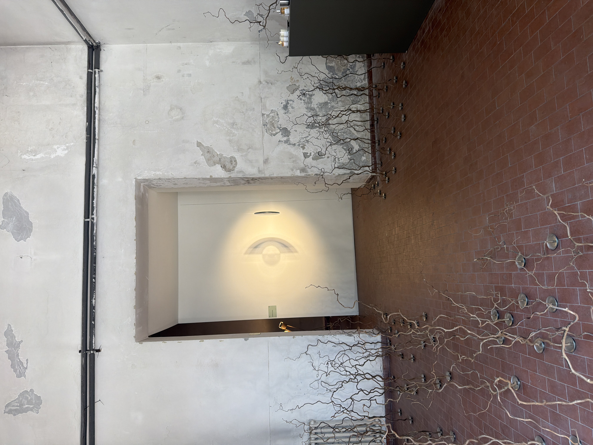 Industrial art installation documented in Milan interior space