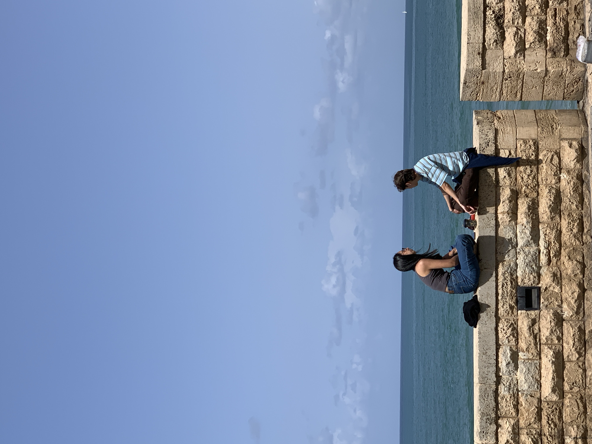 Casual Tel-Aviv moments: oceanside socializing, architecture, broken statue