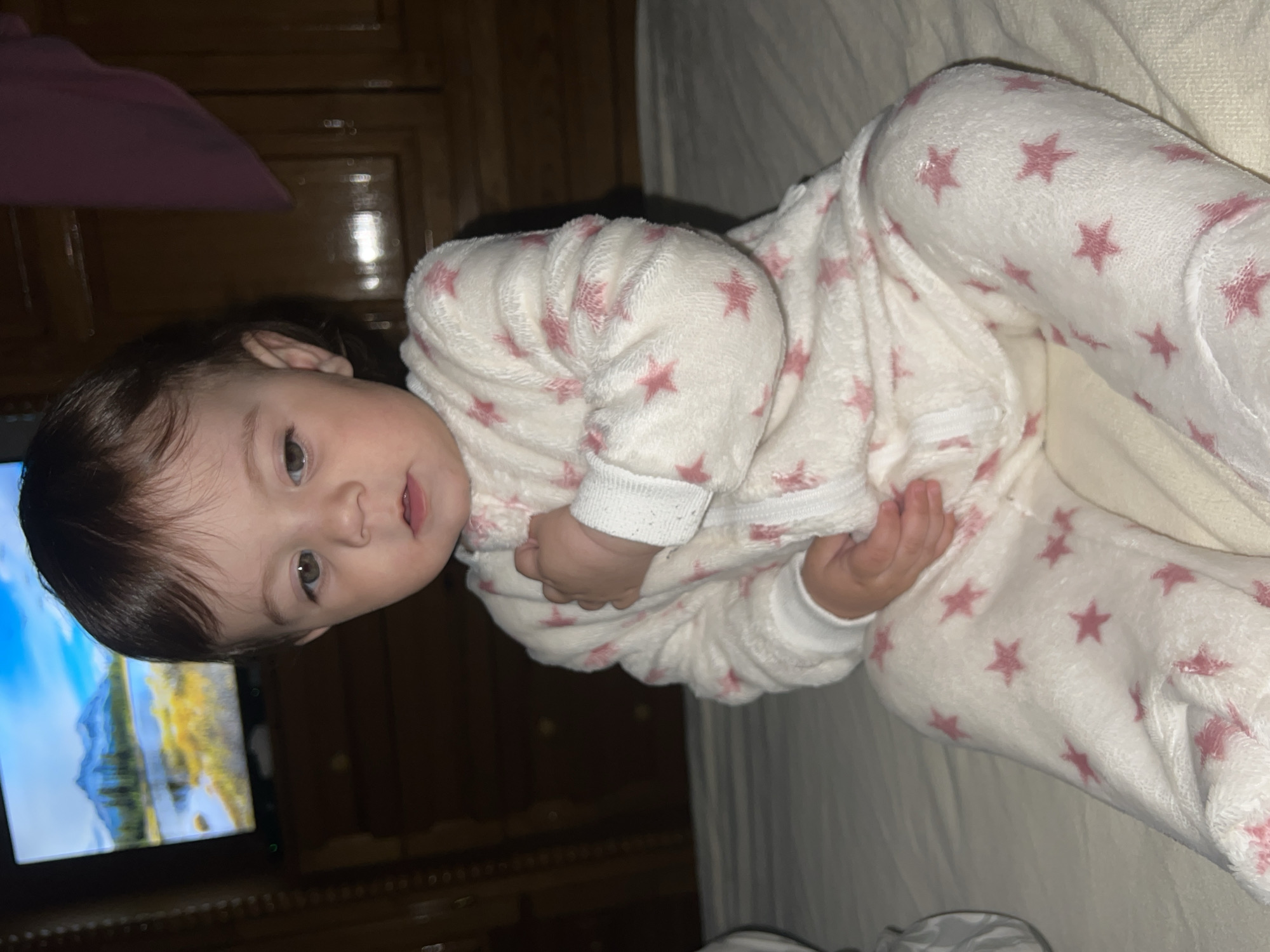 Child in star pajamas photographed at bedtime in Elena