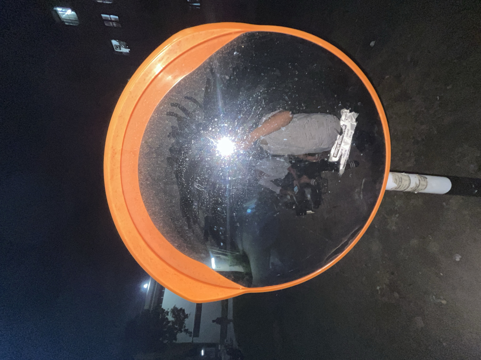 Person takes creative selfie in traffic mirror in Dhaka