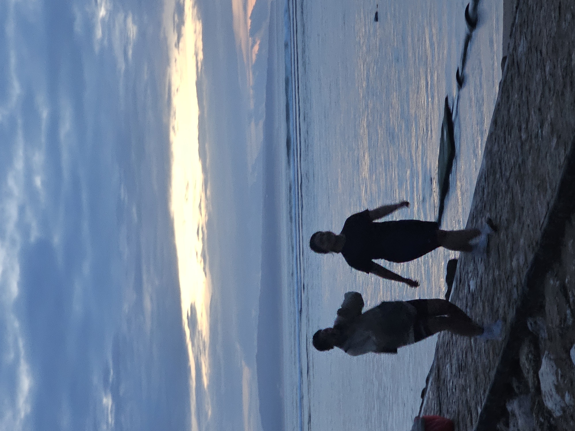 Evening shoreline activities observed in Denpasar, Indonesia