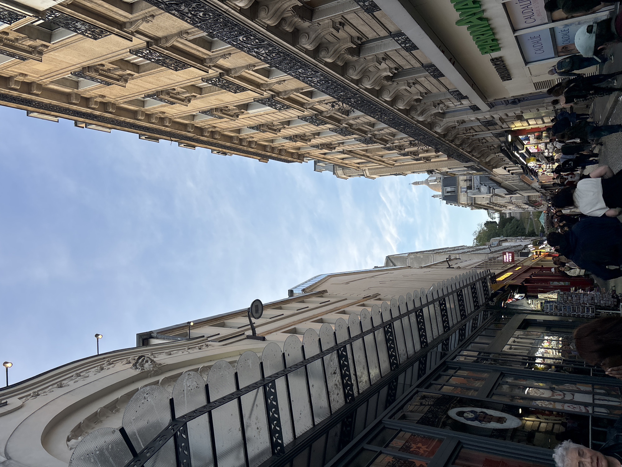 Parisian street scene documented showing classic architecture under blue sky