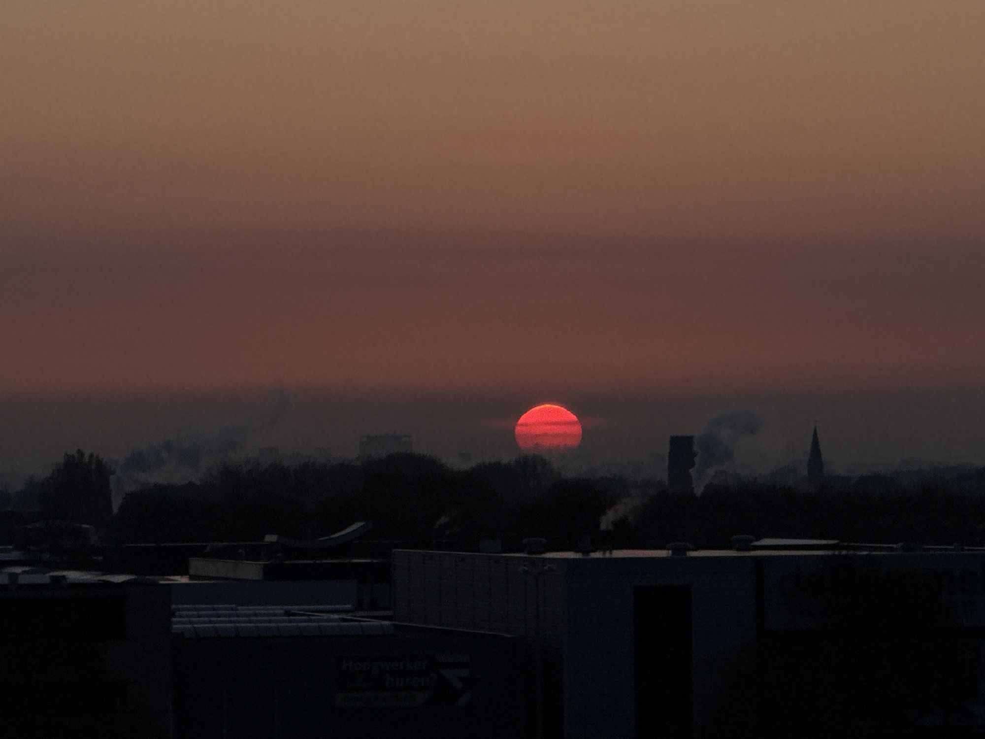 Red sunrise captured over Maasdijk Netherlands skyline