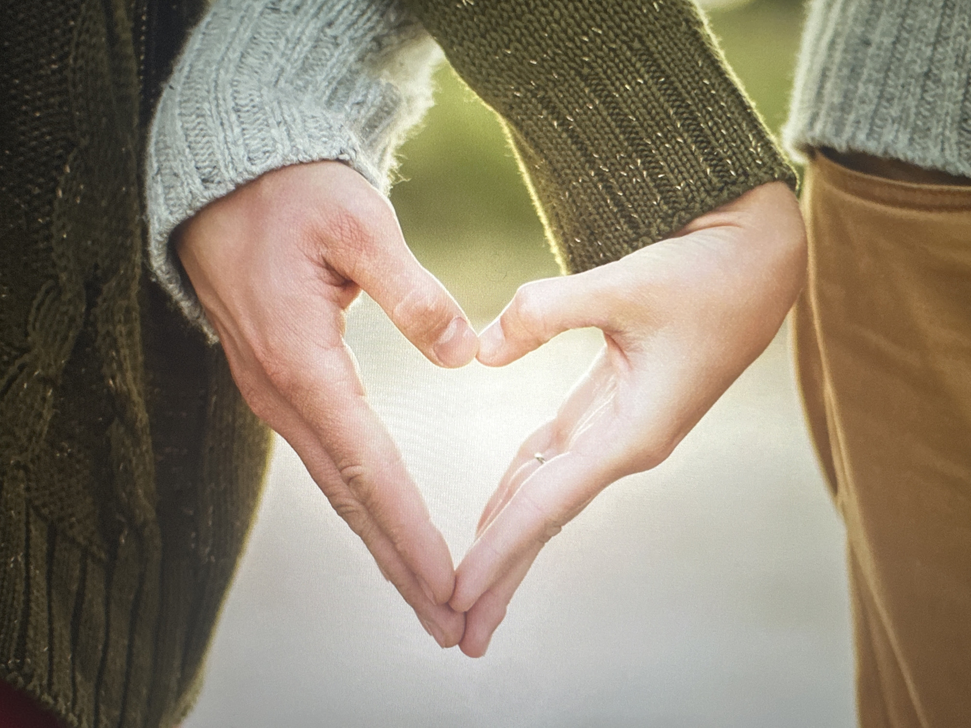 Hands framing a heart against the Bryansk sunset