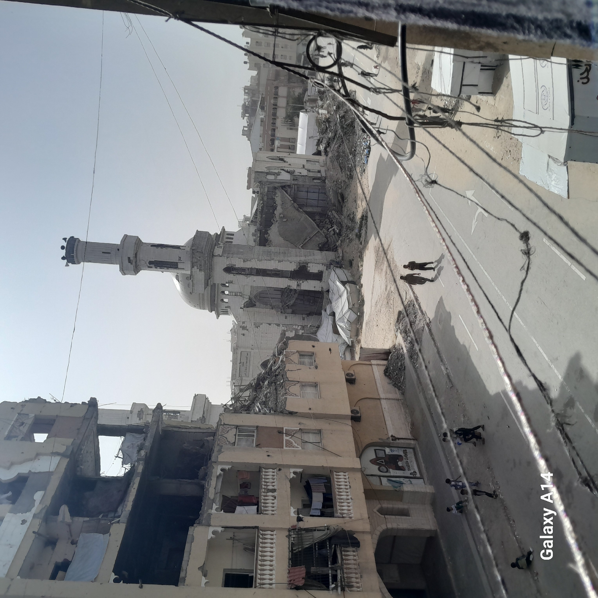 Urban street scenes show temporary arrangements amid damaged buildings