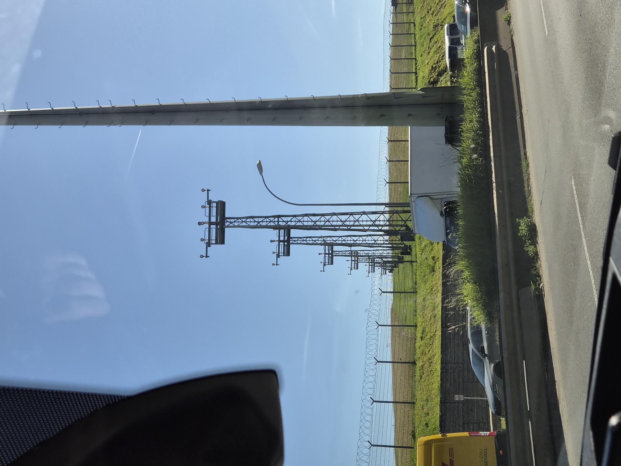 Vehicle travels road alongside Luxembourg Airport perimeter Friday morning