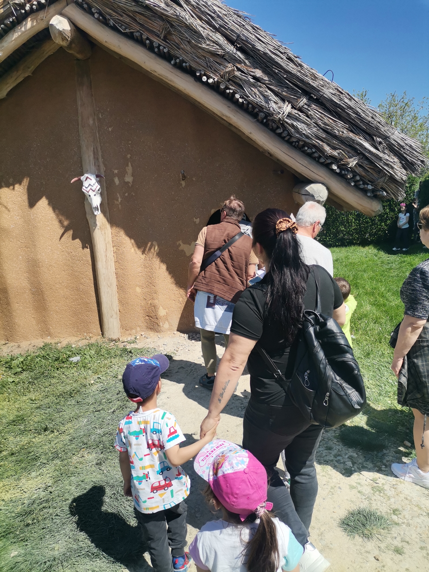 Family visits traditional Bulgarian building with tribal decorations