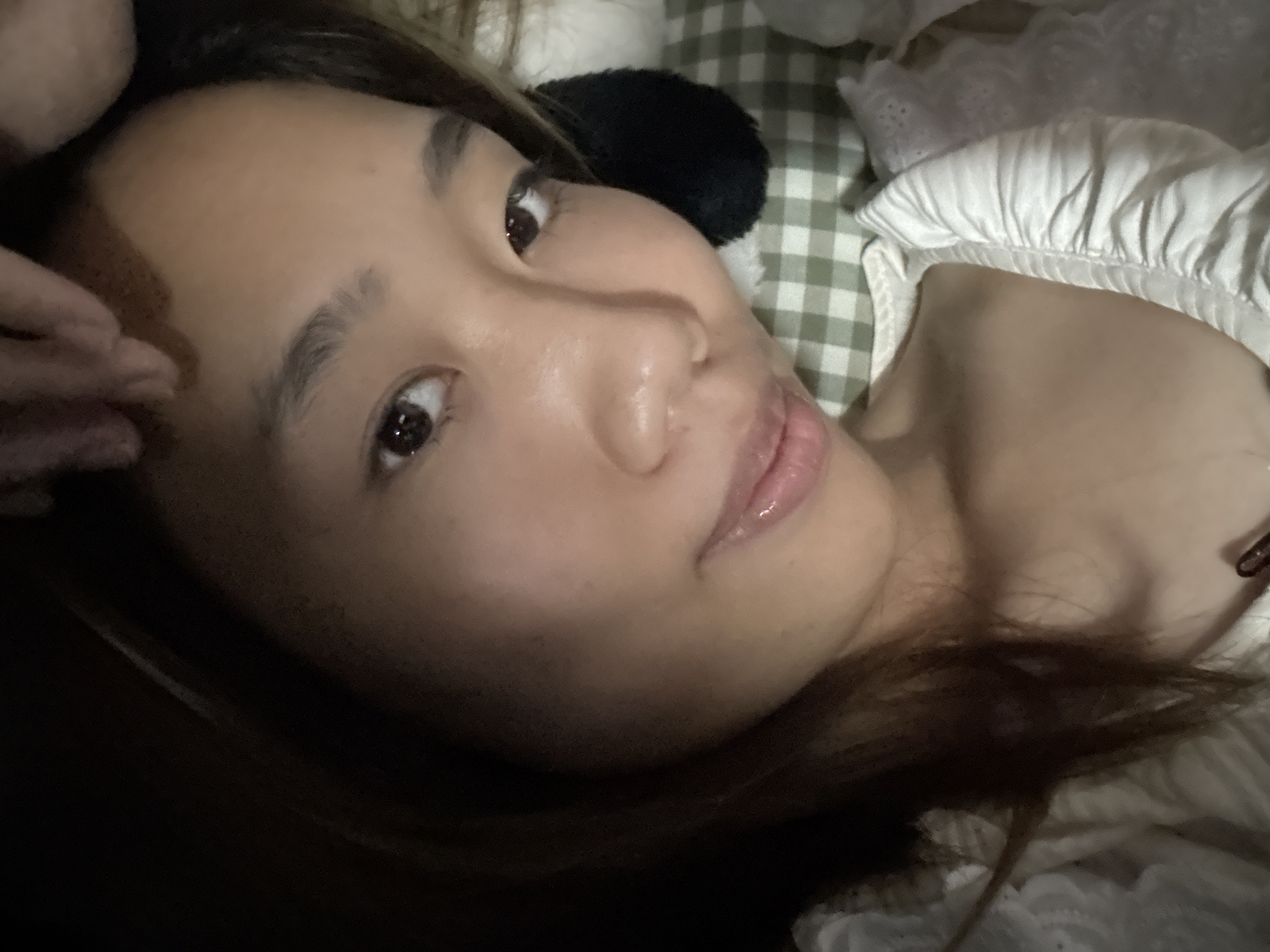 Woman poses with plush toy on bed in China