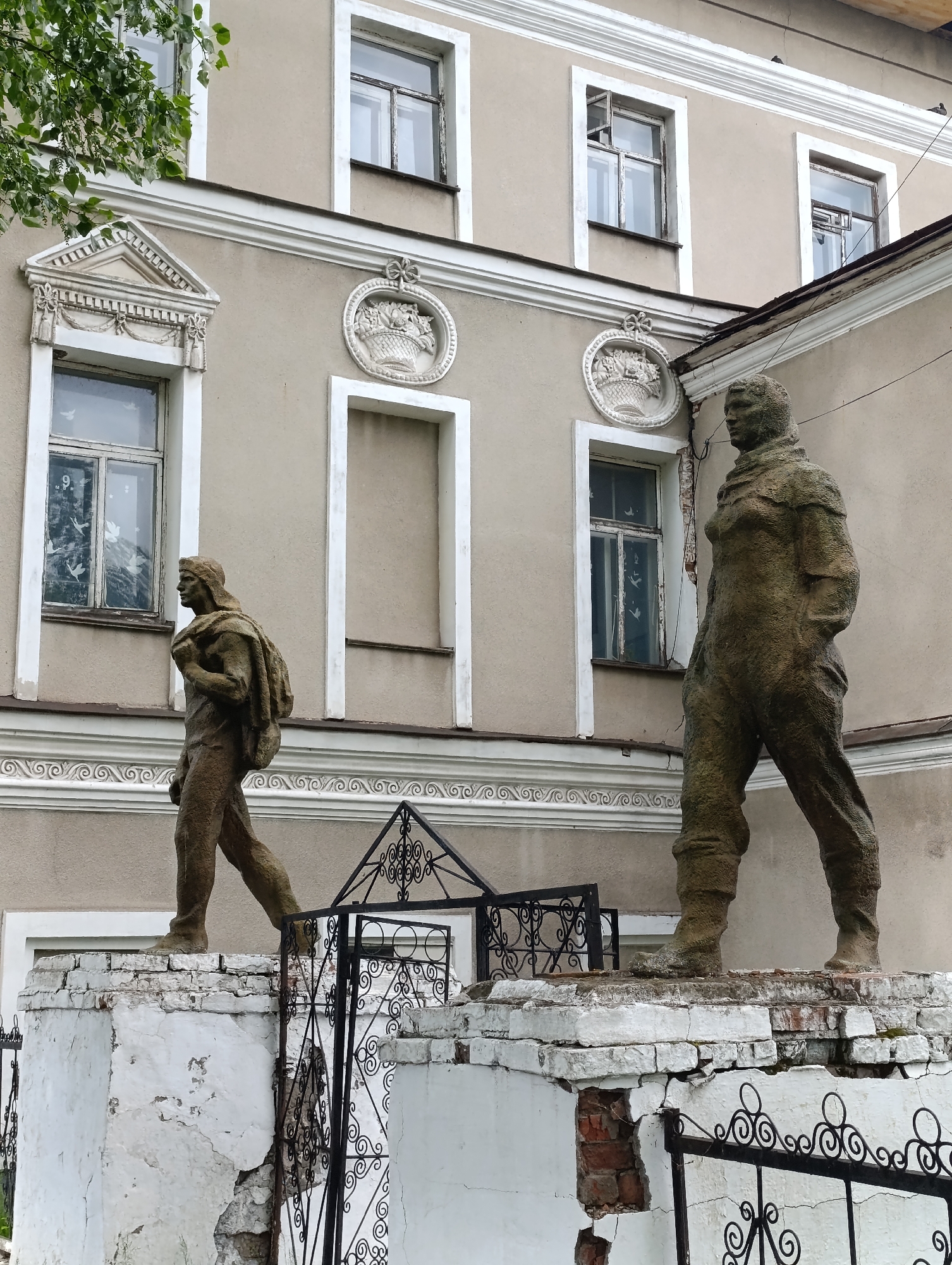 Weathered statues observed on crumbling base in Tara, Russia