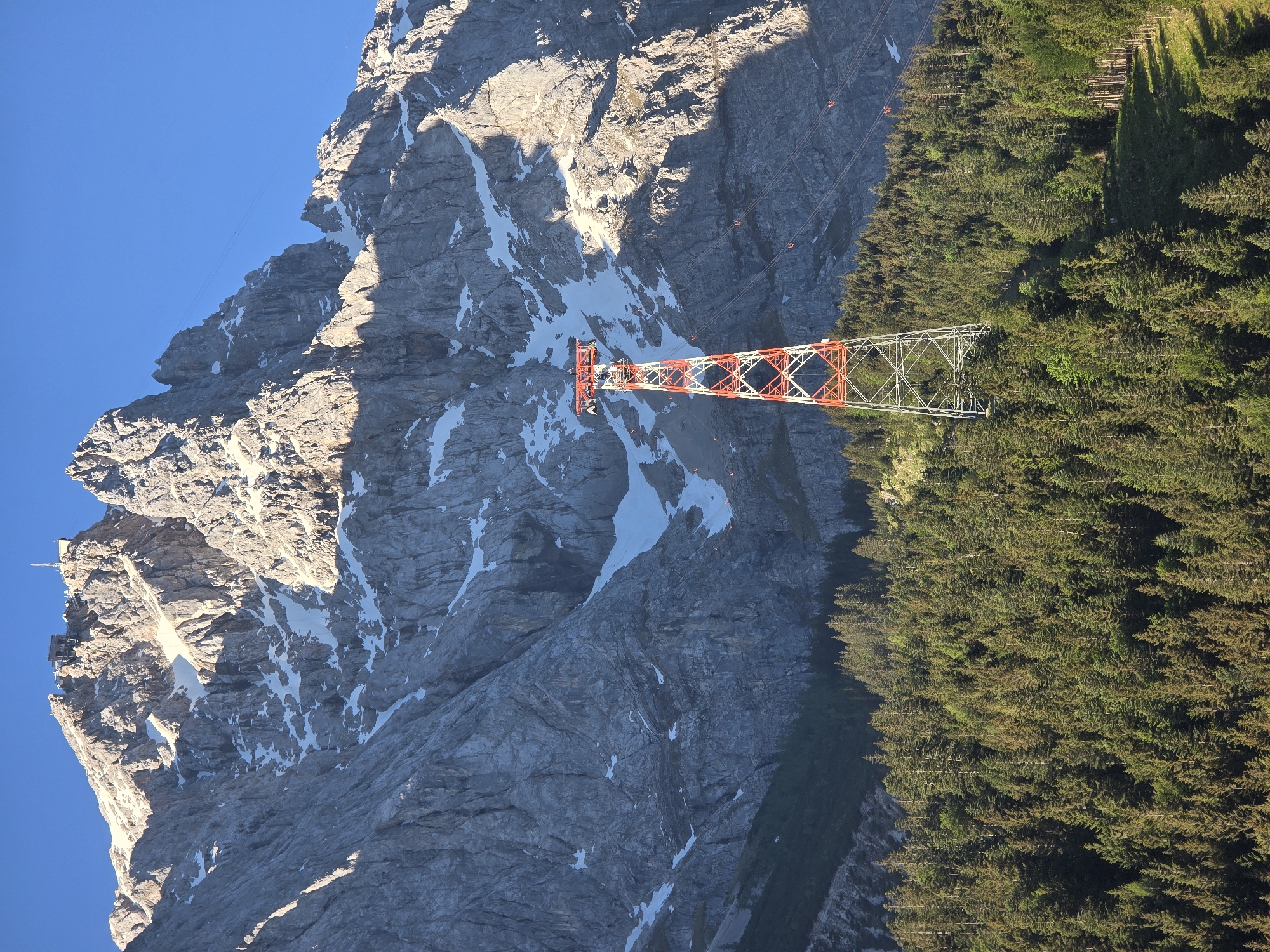 Tourist documents Zugspitze cable car system on clear morning