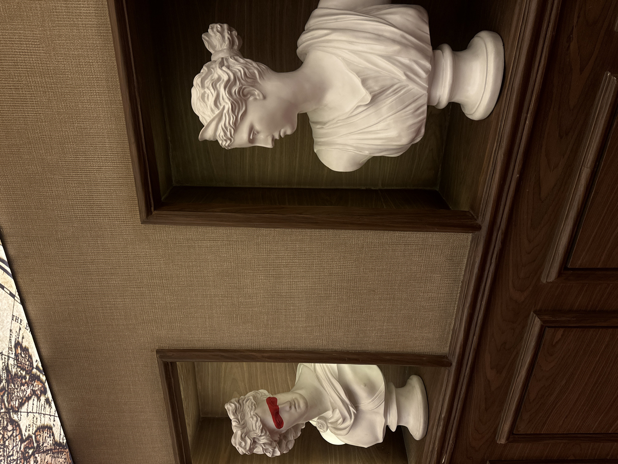 Man interacts with classical busts in Nigerian indoor display