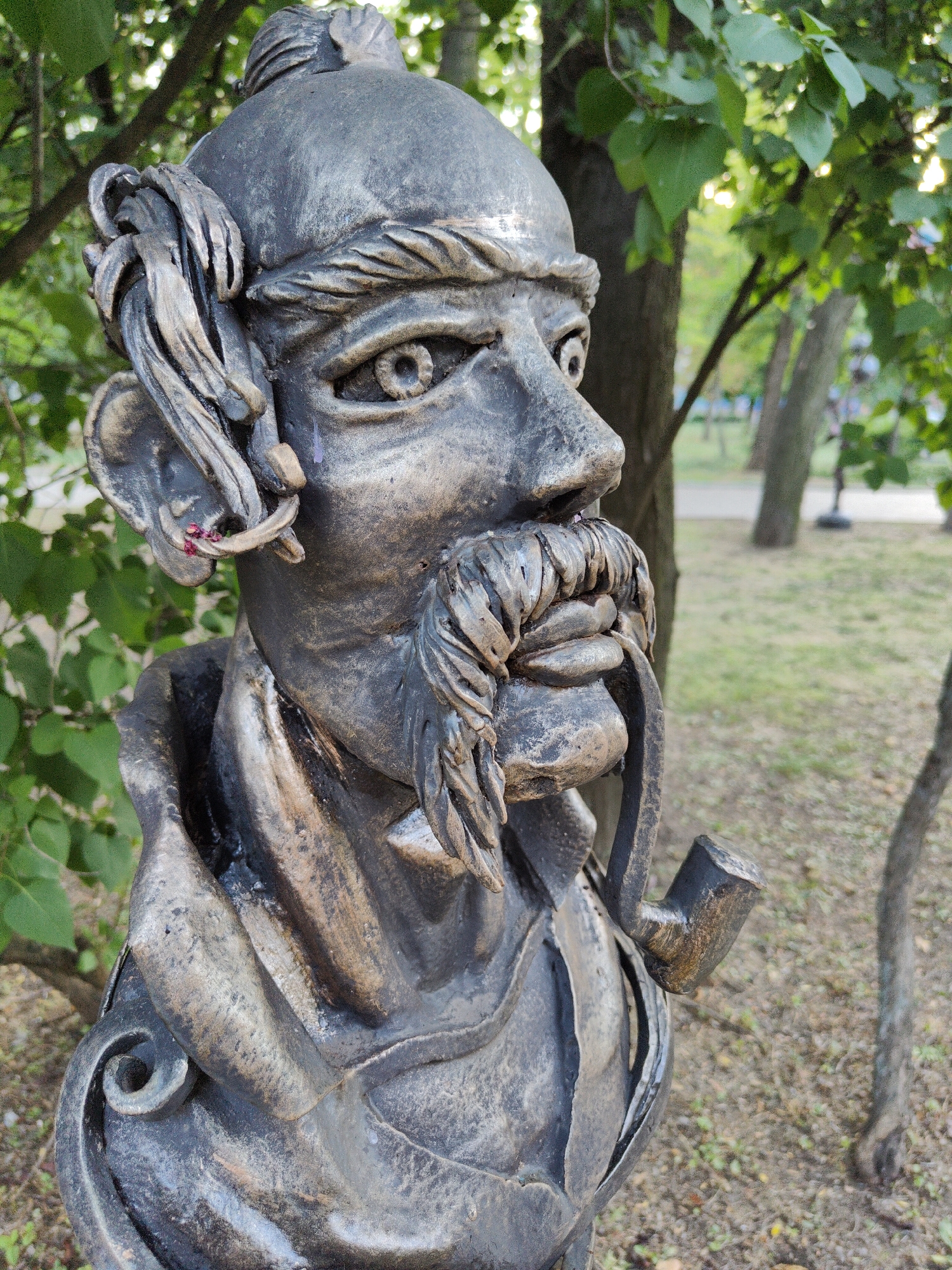Donetsk park sculptures, ironwork gates, and garden flowers