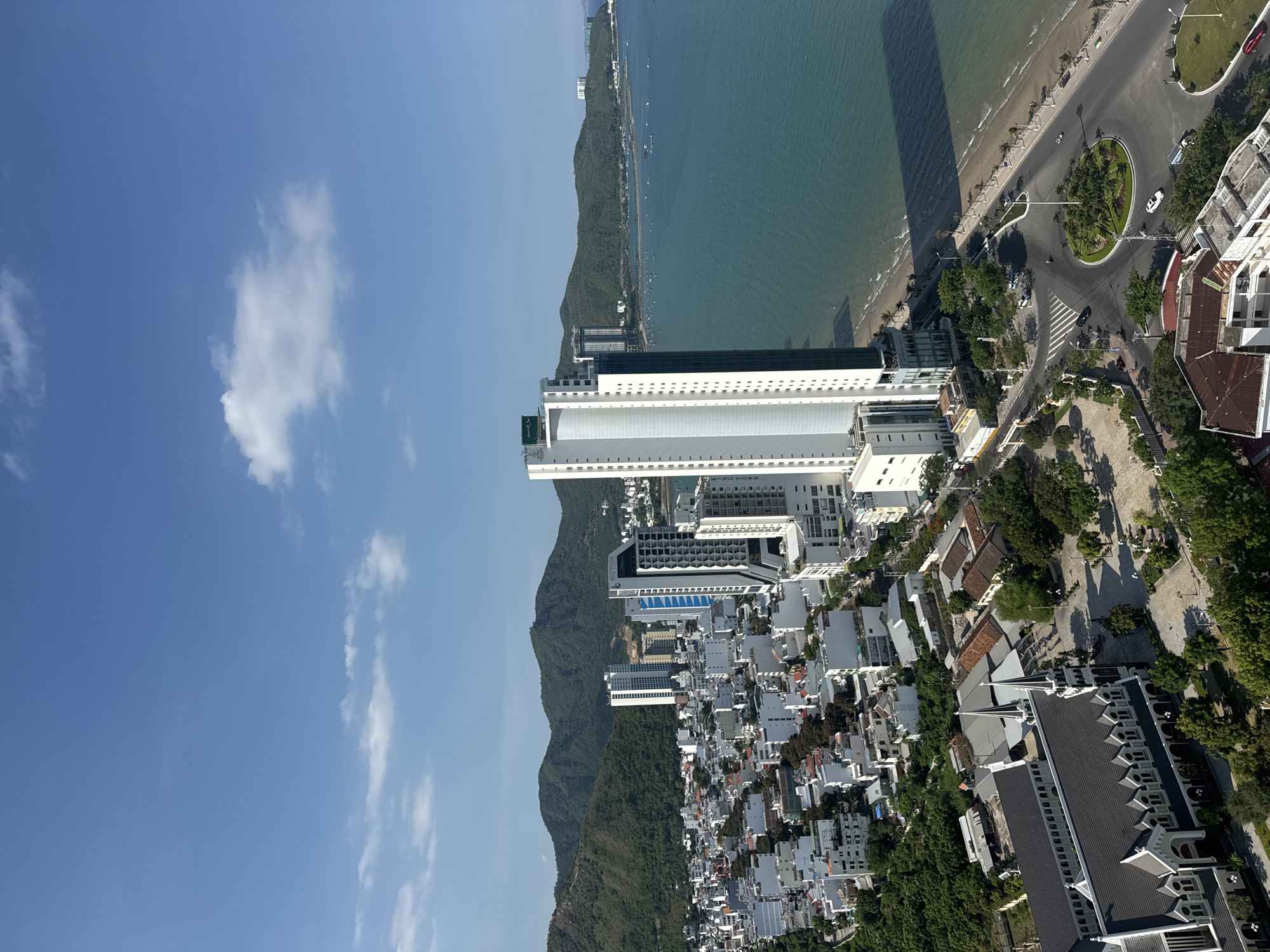 Aerial views of a mountain-backed coastal city, plus one odd clip out