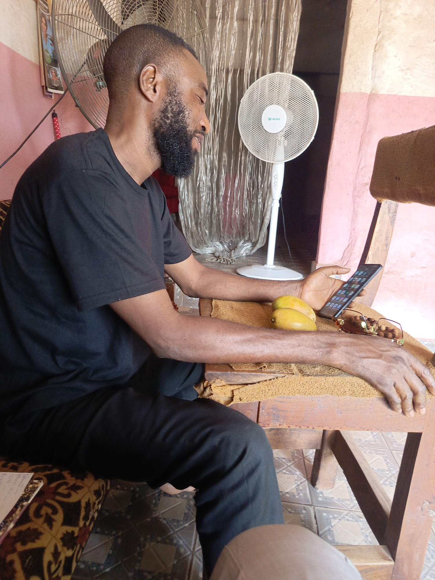 Man with smartphone observed in quiet moment in Doma