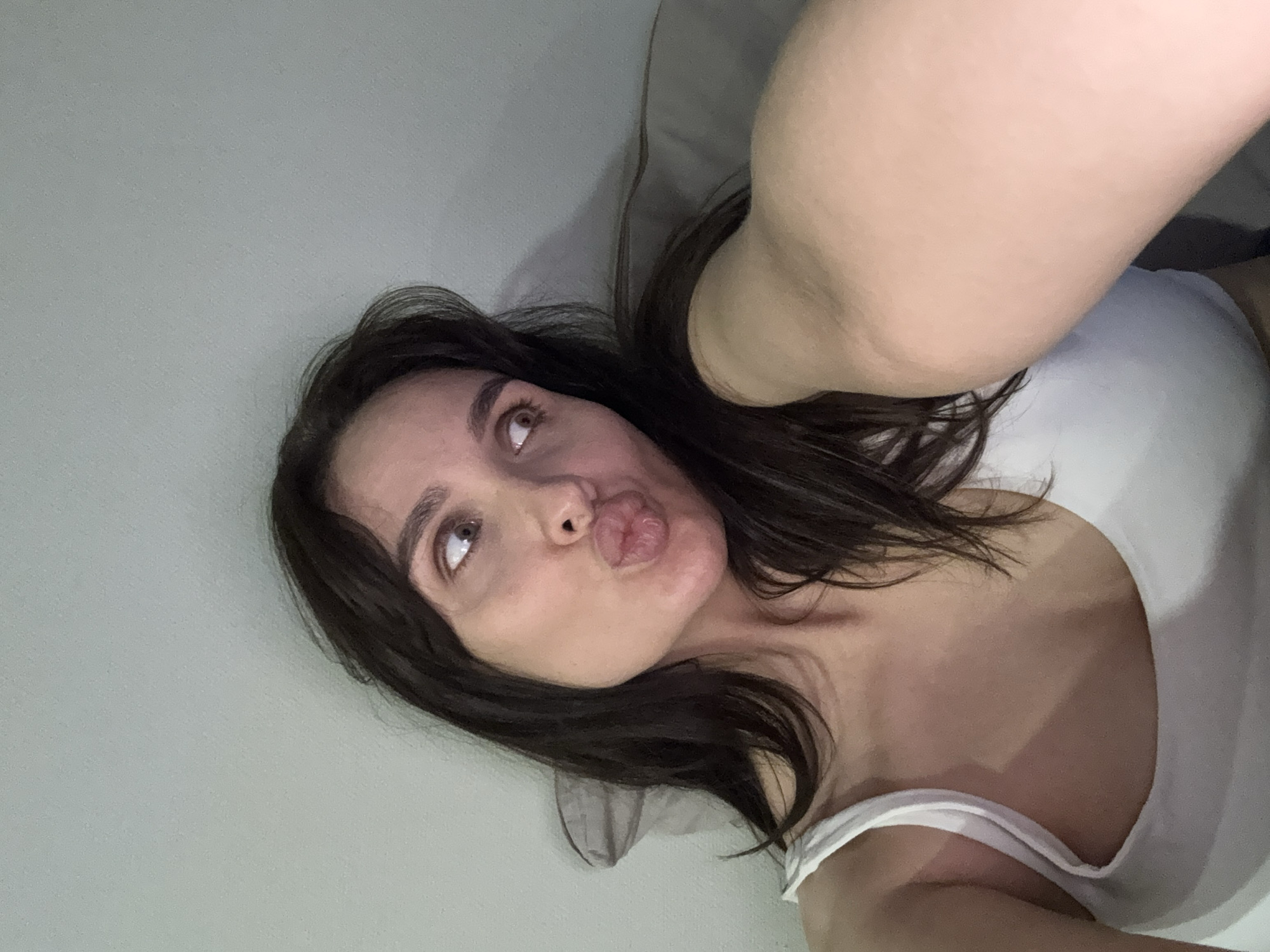 Woman takes selfies in bedroom during morning in Chaikovsky