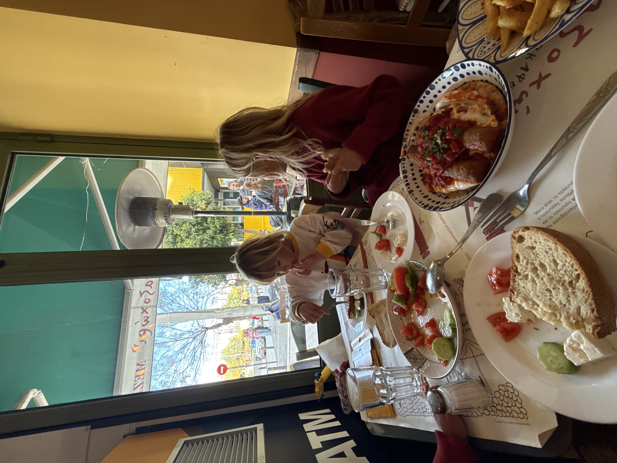 Children dine at Athens restaurant table