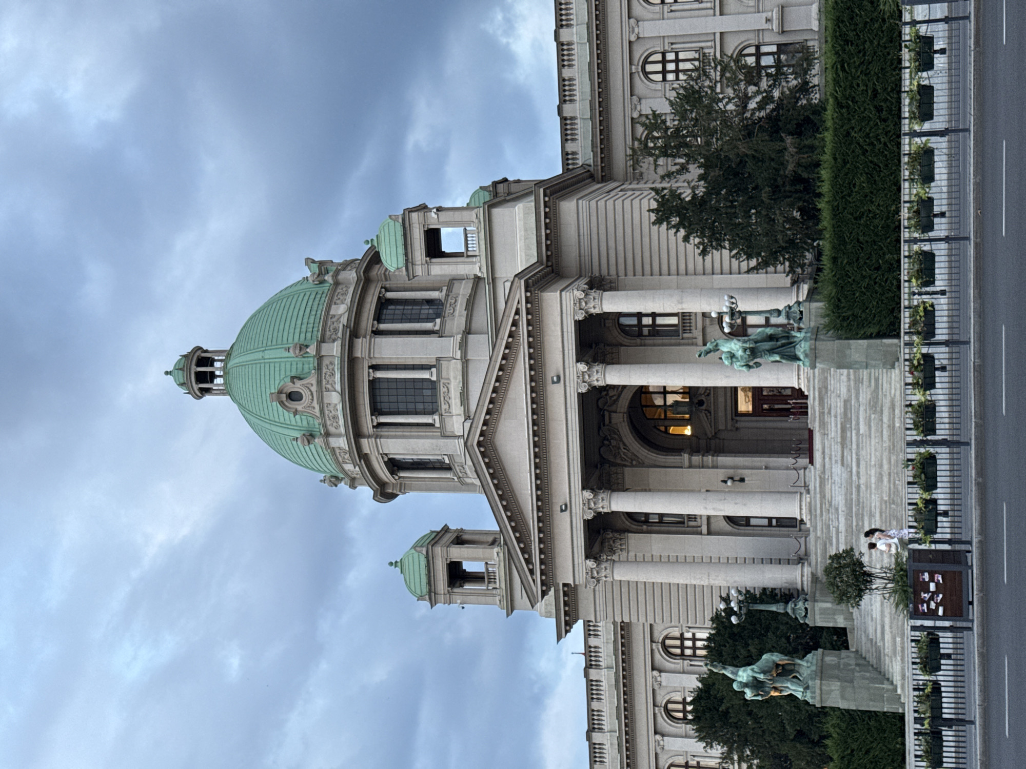 Street-level pause near a grand domed building in Belgrade