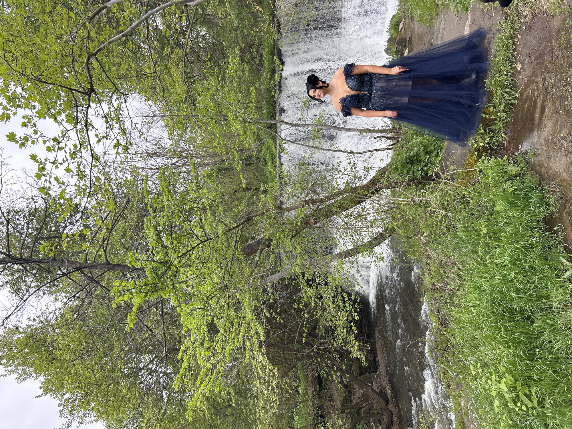 Woman in blue gown observed at waterfall near Parvenets