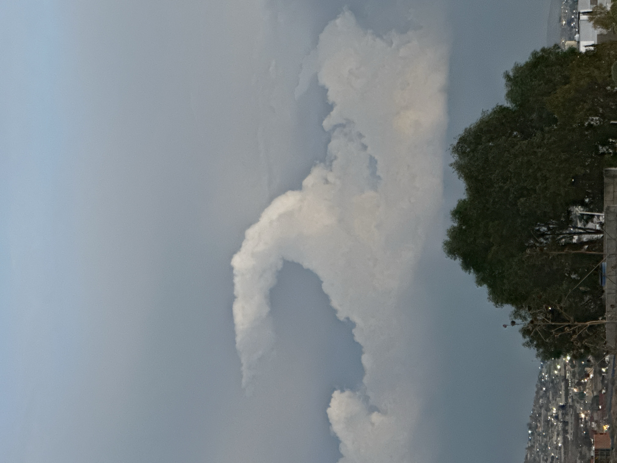 Cloudy night sky photographed over hillside community in Puebla