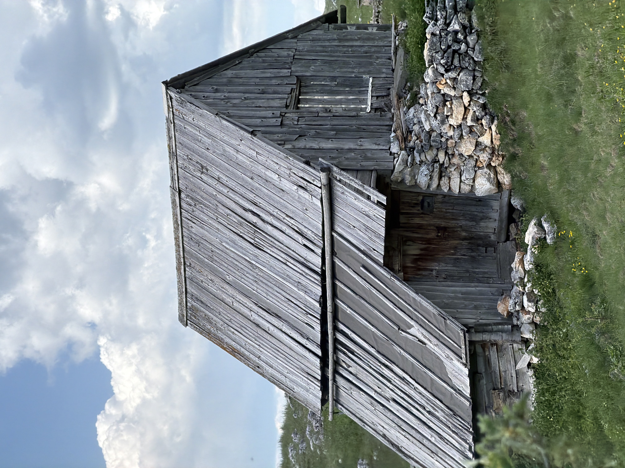 Weathered wooden barn spotted on Montenegro hillside