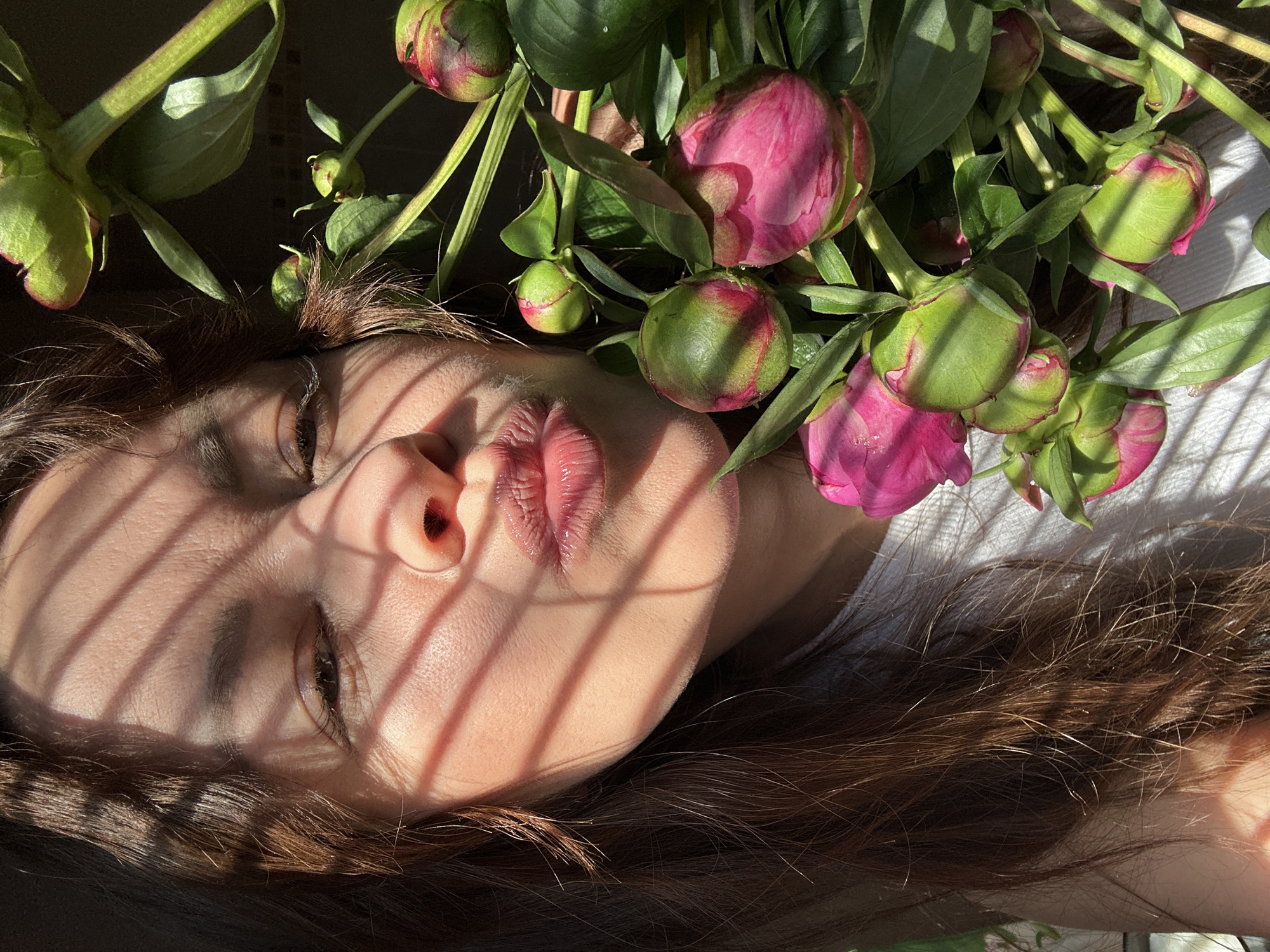 Woman enjoys morning breakfast with peonies in Chaikovsky, Russia