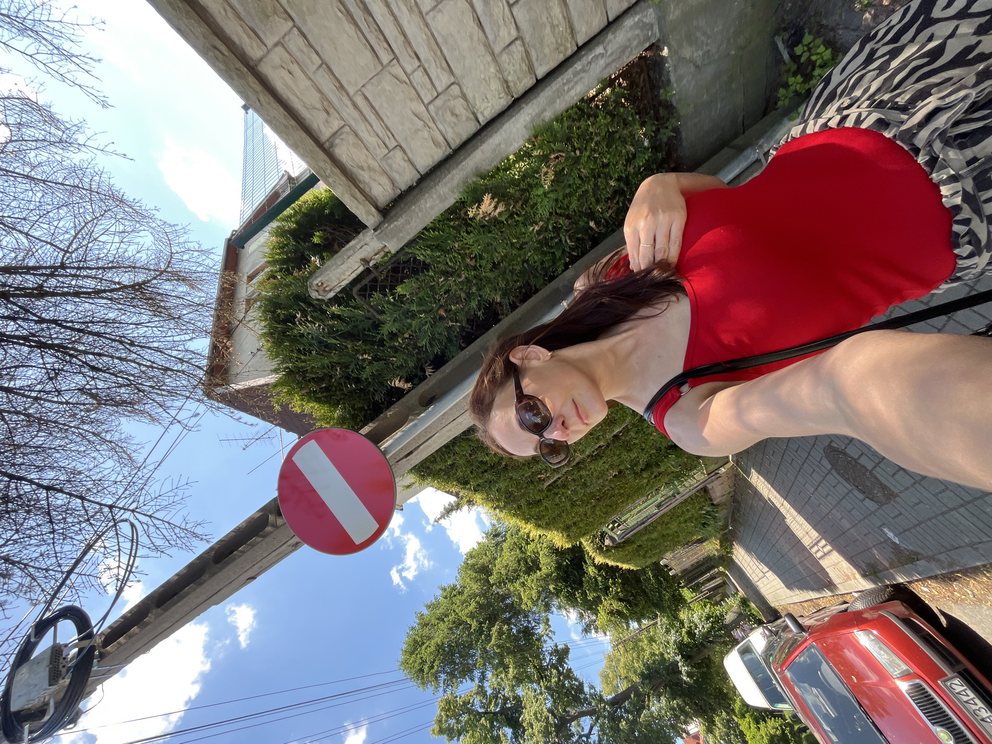 Woman documents sunny day with selfies across urban locations