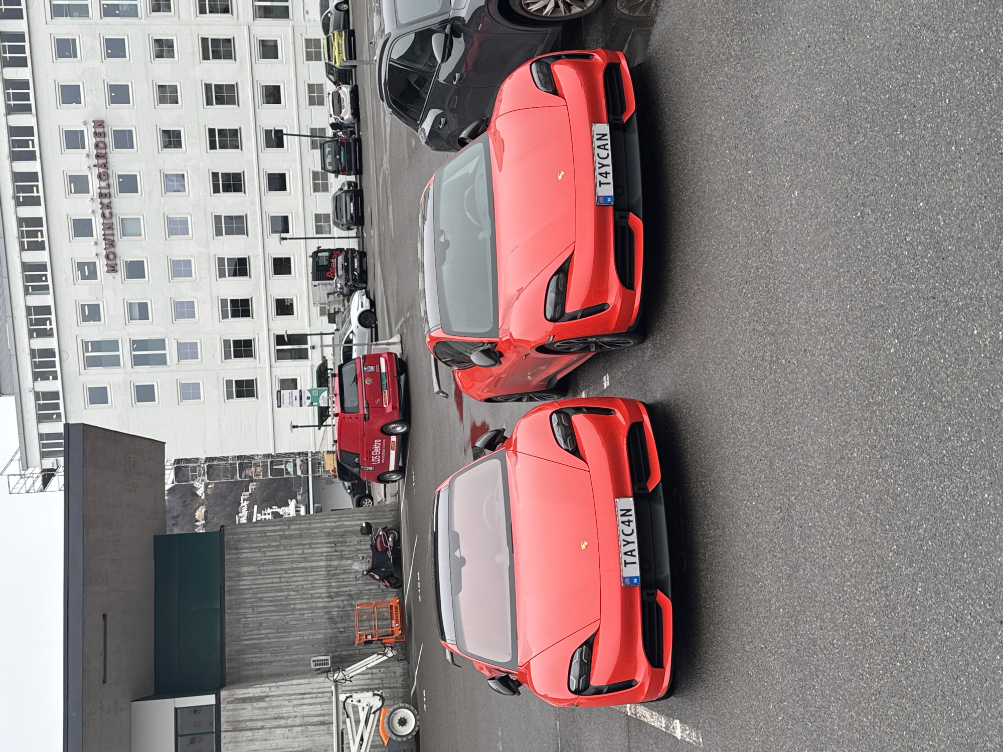 Twin red Porsche Taycans spotted with matching plates in Bergen