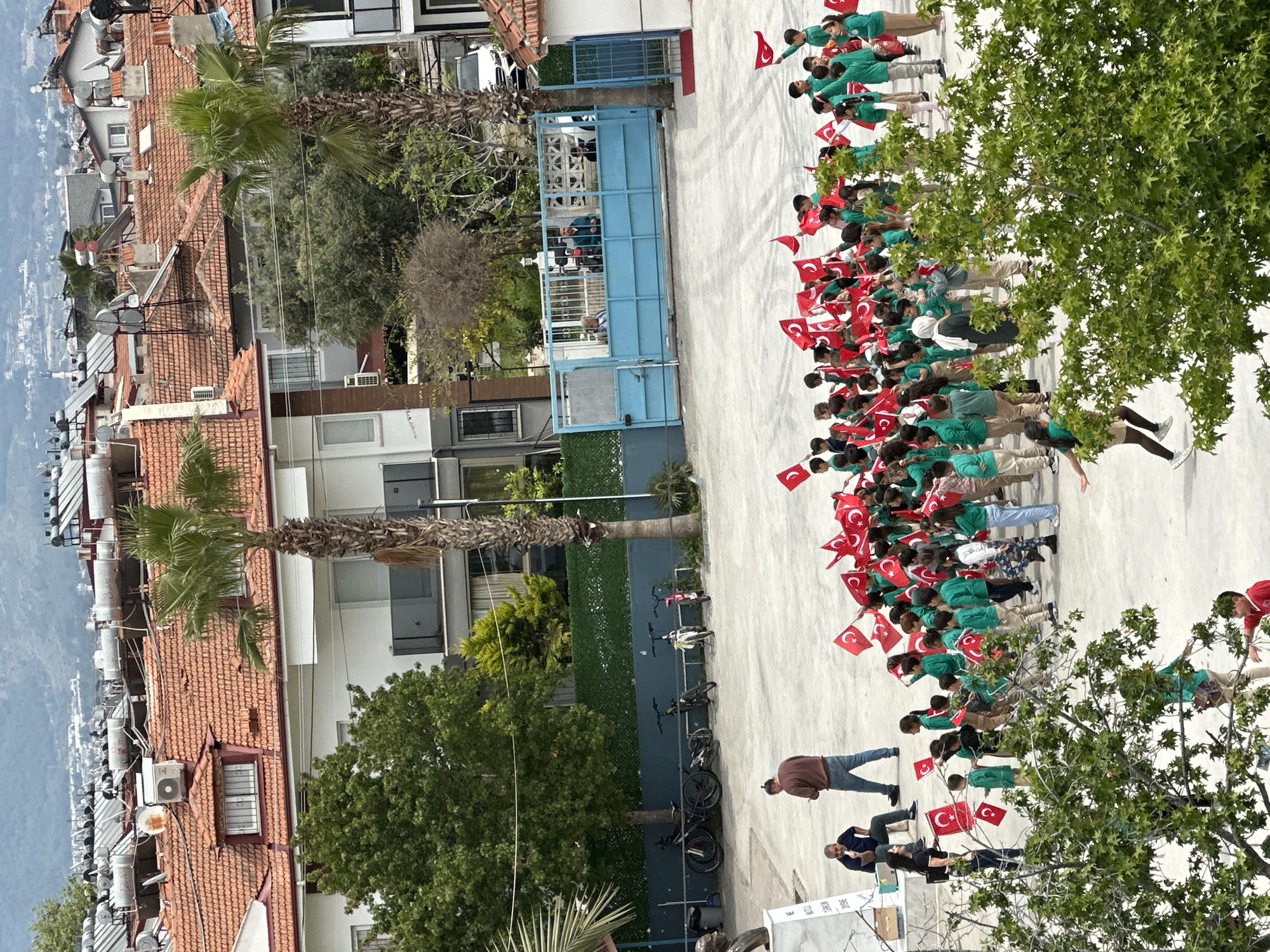 Students hold Turkish flags during school event in Fethiye