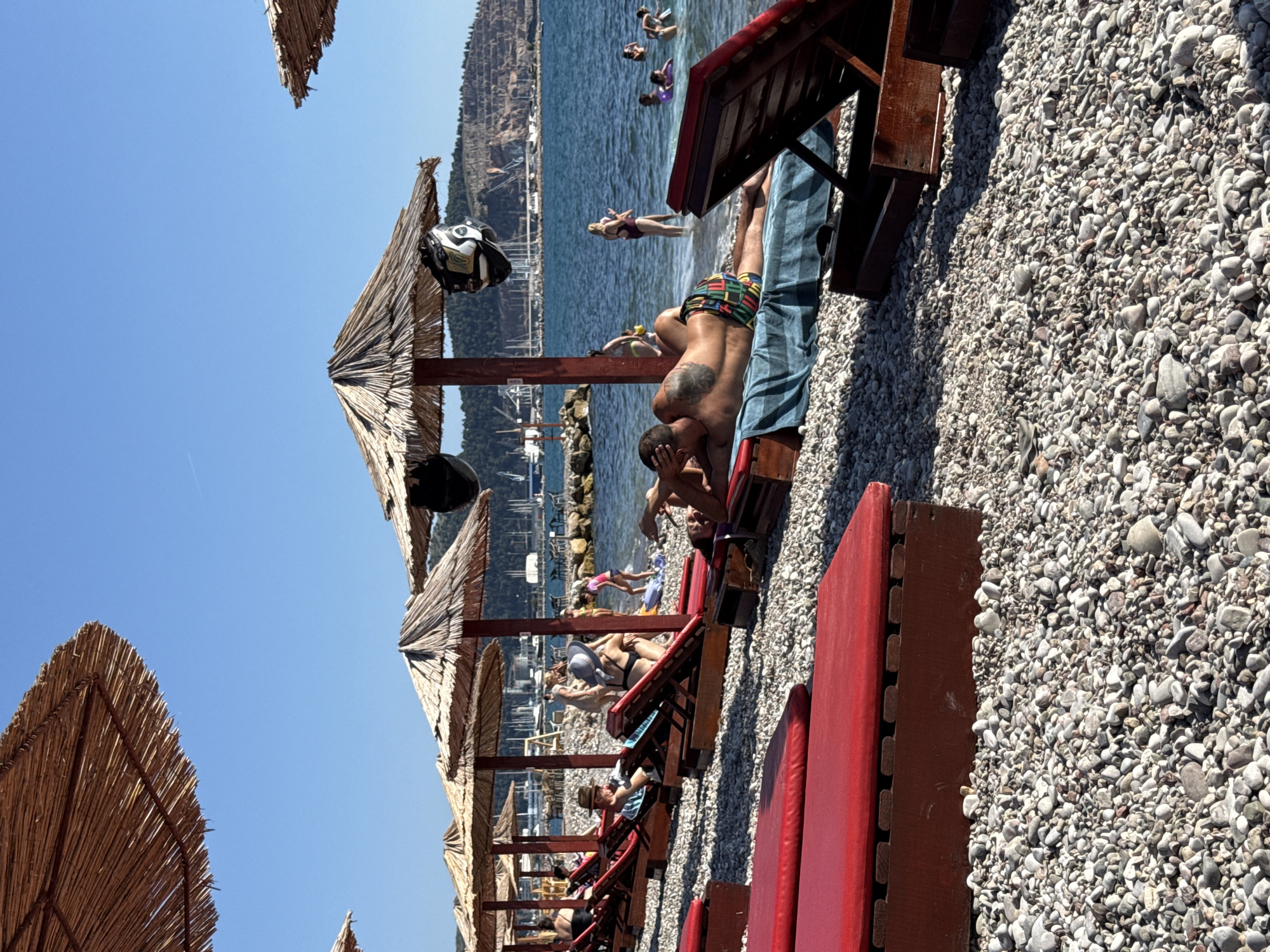 Sunny afternoon on a pebble beach in Bar, Montenegro