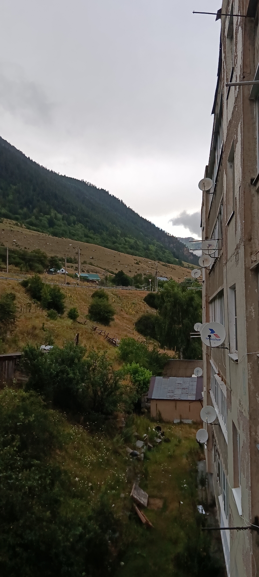 Misty mountain town: residential Teberda under overcast skies
