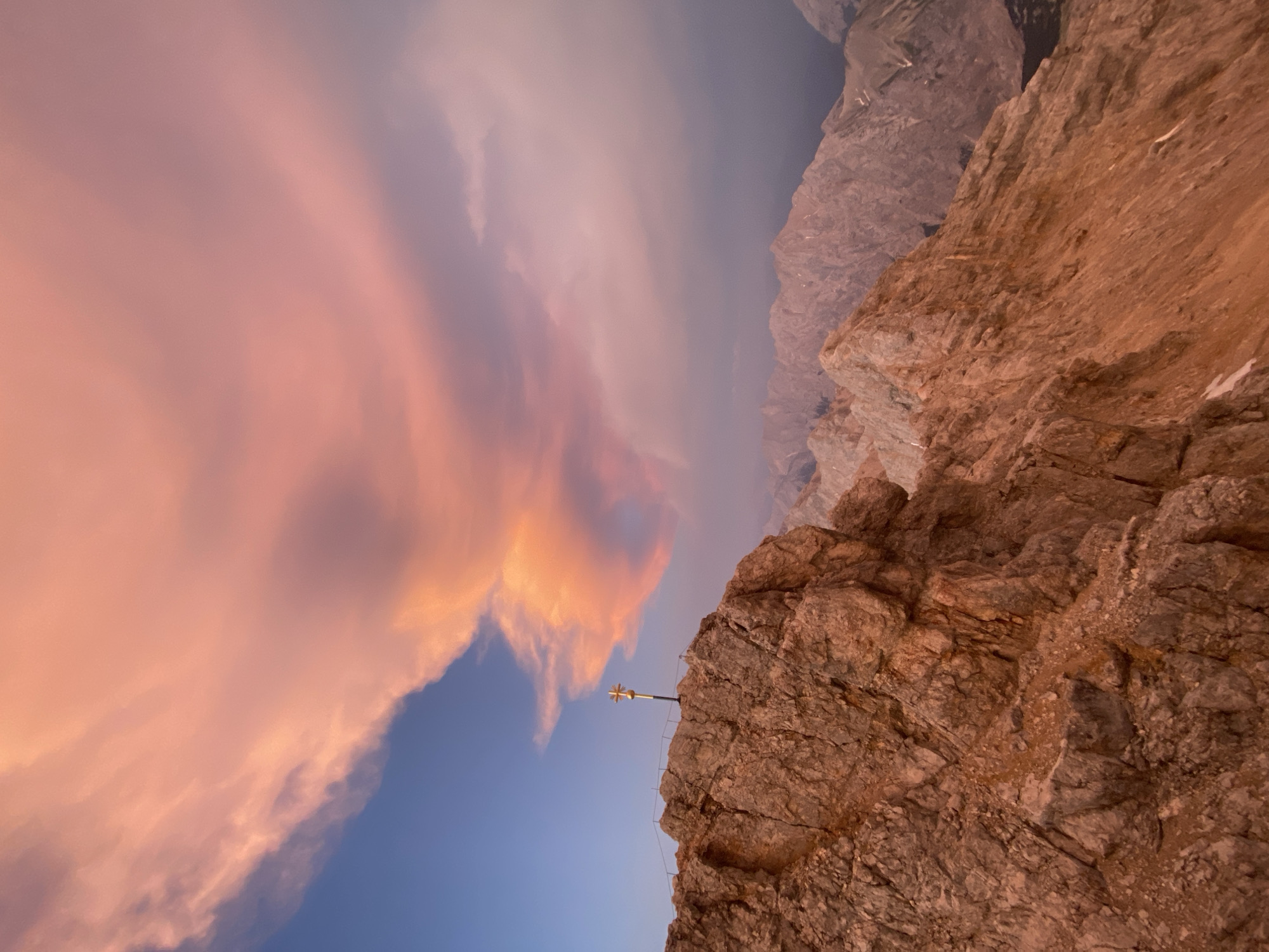 Zugspitze summit at golden hour, cross and dome in frame