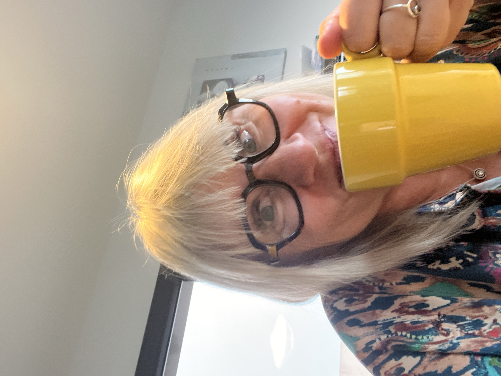 Woman drinks from yellow mug in early morning Chambœuf