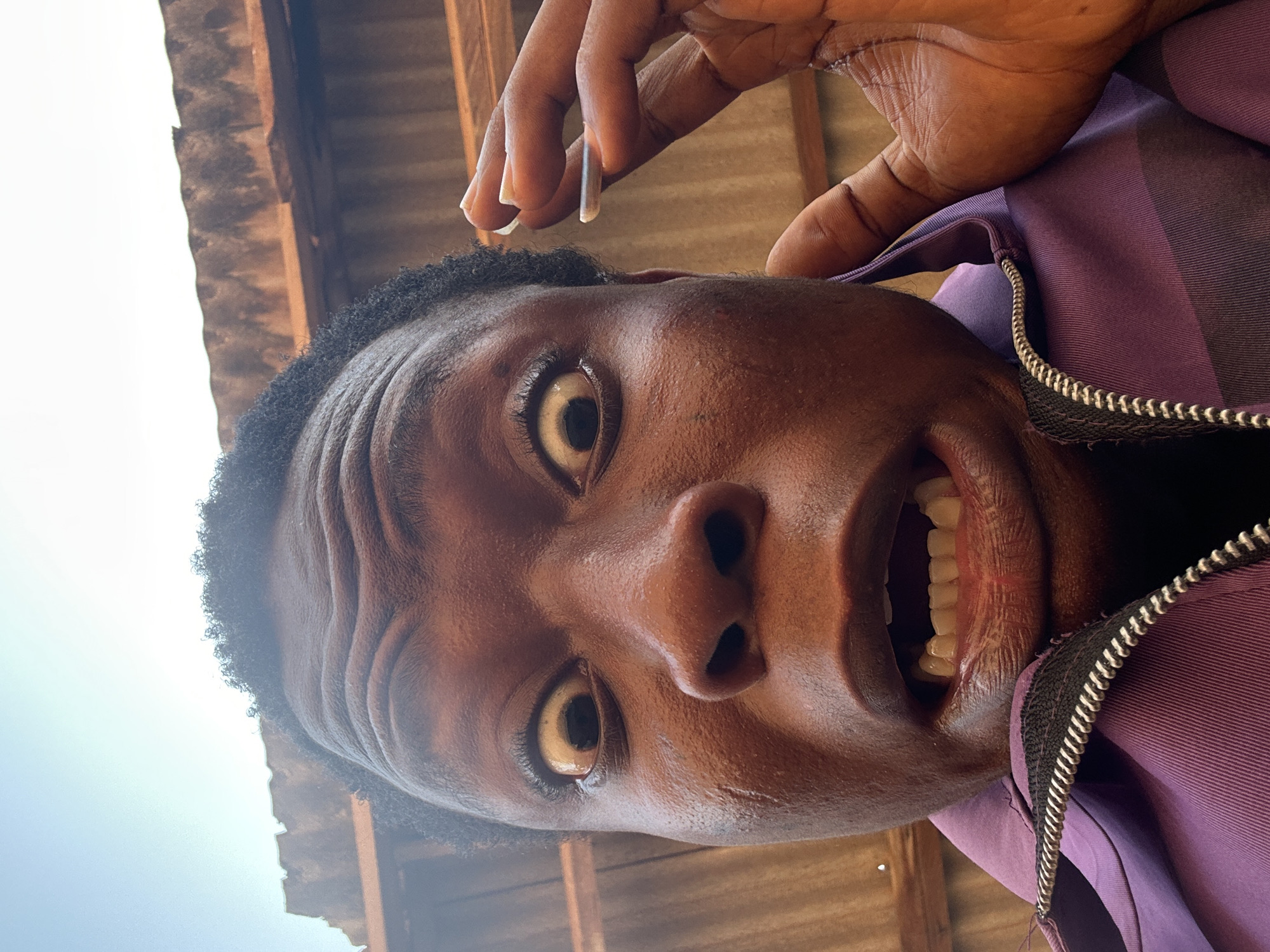 Man takes series of expressive selfies in purple jacket