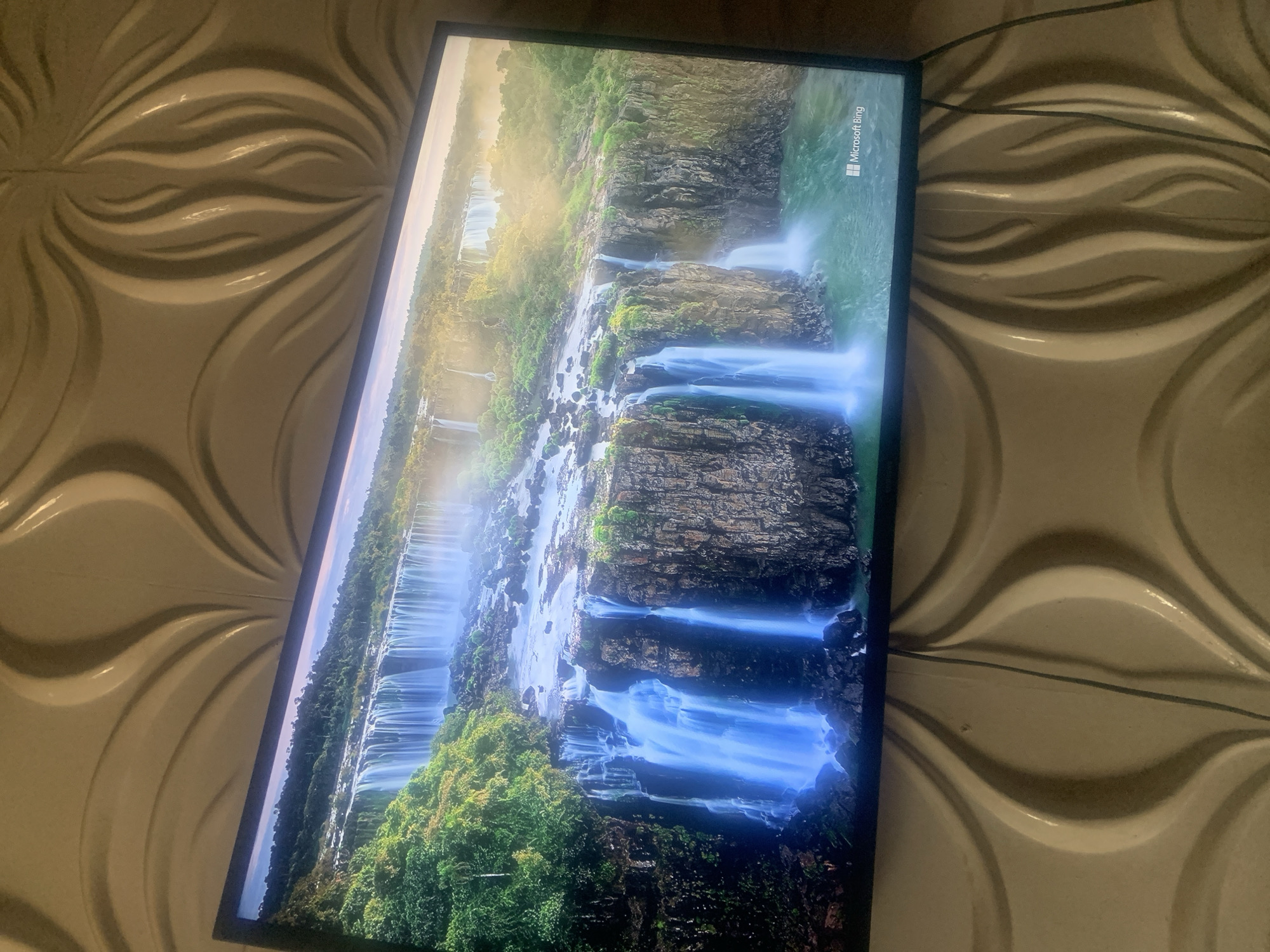 Television displays Microsoft Bing waterfall screensaver or wallpaper image