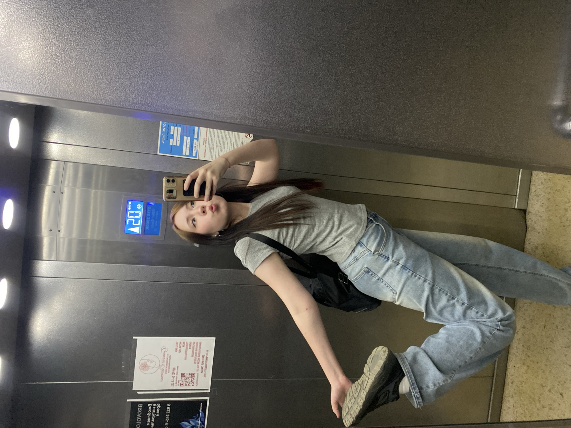 Woman takes selfies, black cat spotted in building area