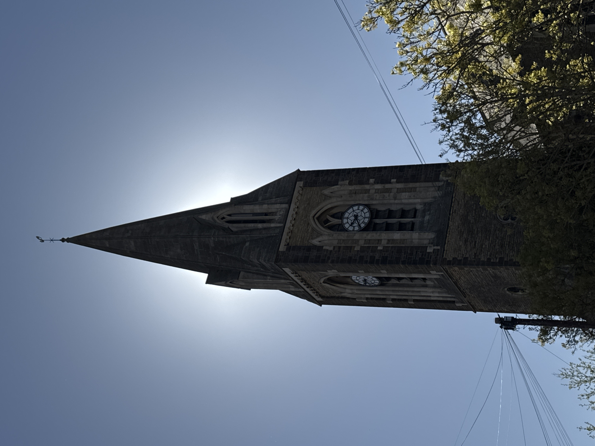 Historic church spire photographed under clear skies in Northampton