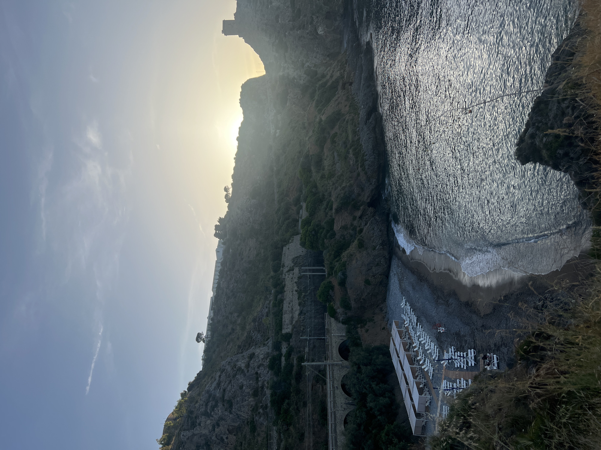Tourists explore coastal cliffs and caves in Sperone, Italy