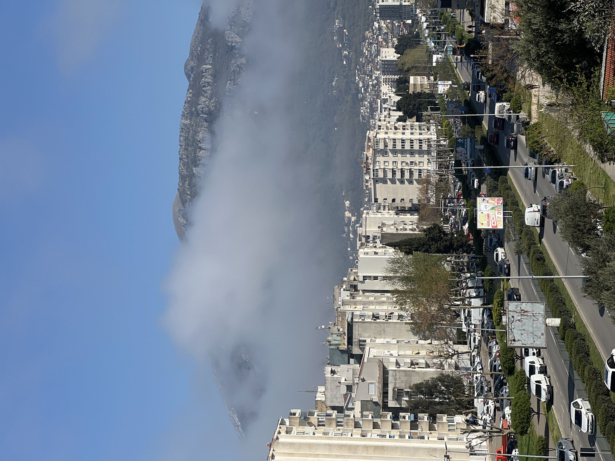 Morning fog blankets Bar, Montenegro mountains; hearts shared