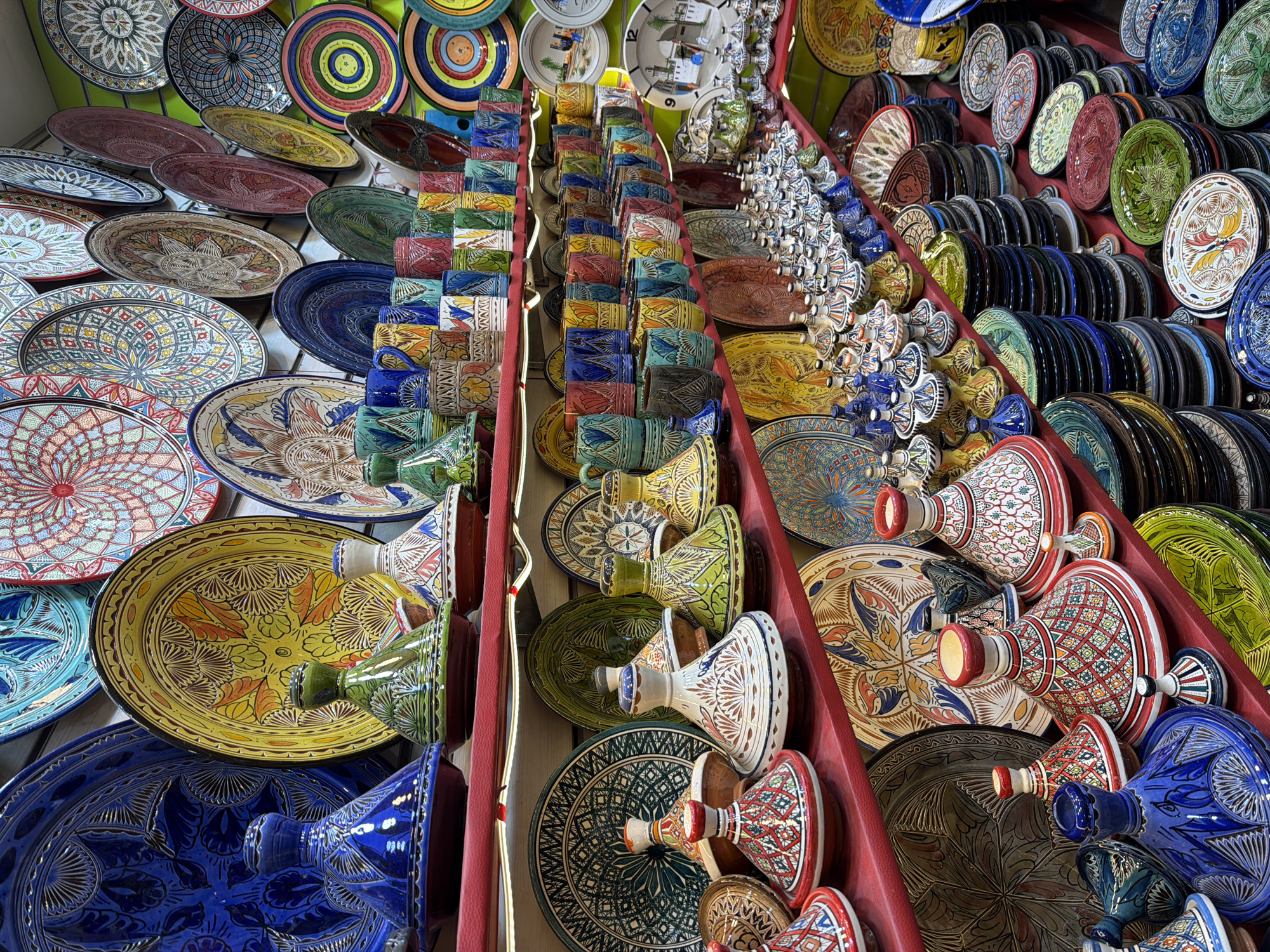 Tourists browse busy market stalls in Marrakesh thoroughfare