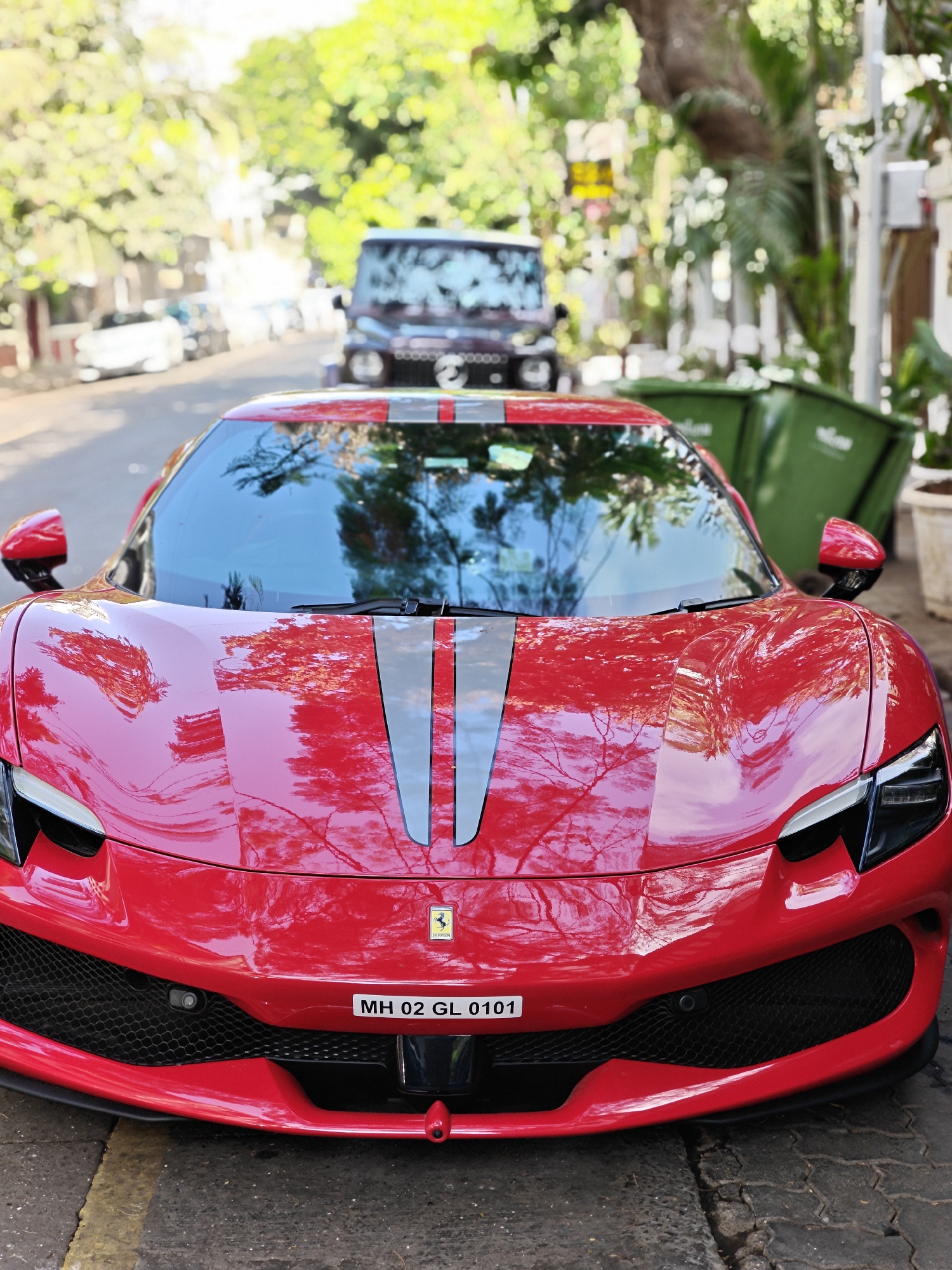 Red Ferrari draws attention on Mumbai street amid casual moments