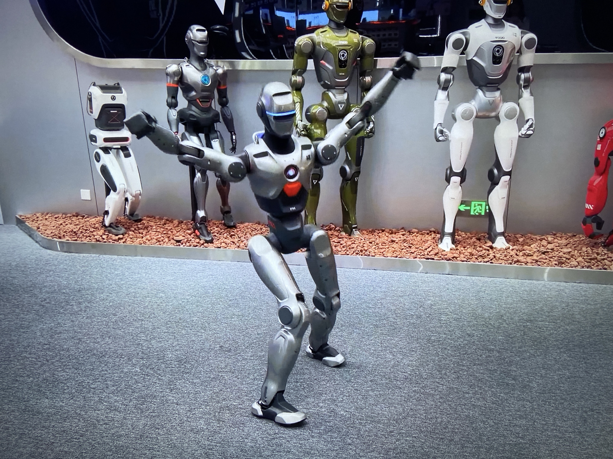 Robots and luxury cars displayed at unknown exhibition venue