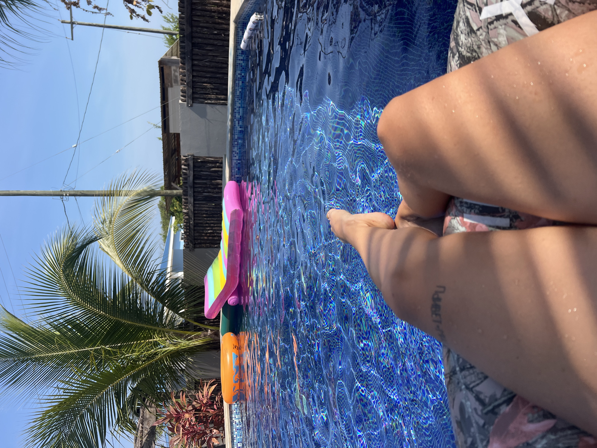 Person enjoys poolside evening in Placencia, Belize