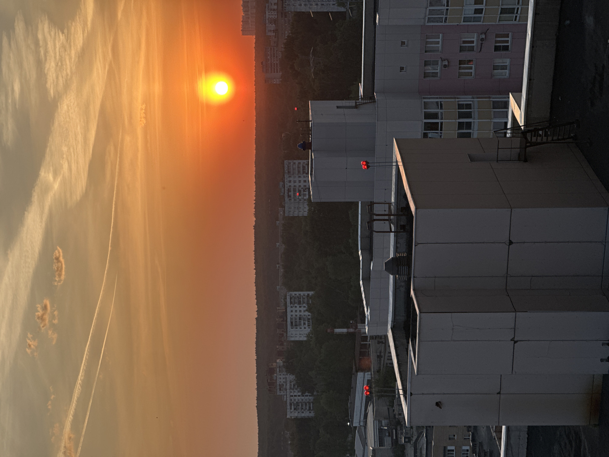 Sunset observed over Zhukovka cityscape with orange skies