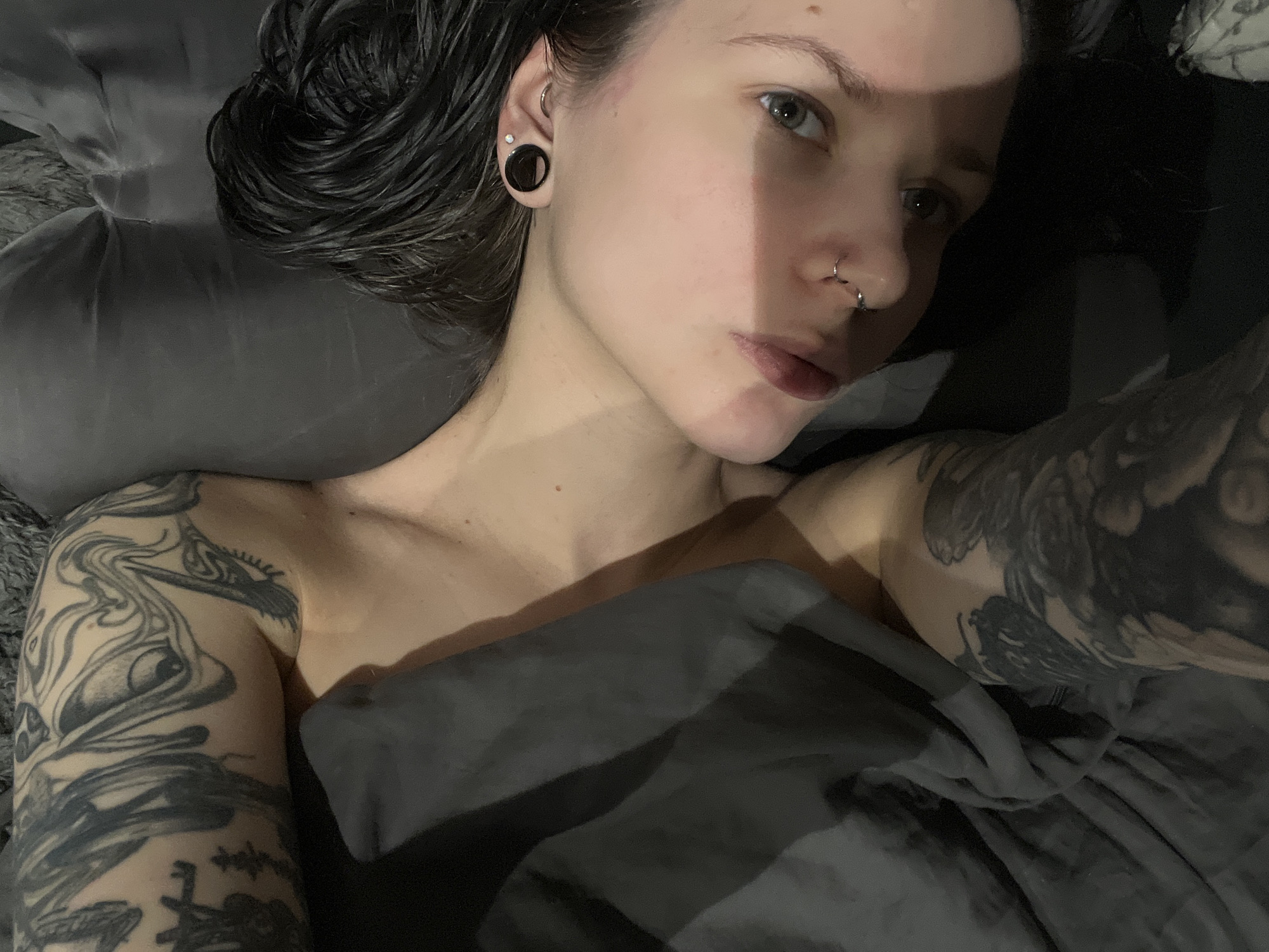 Tattooed individual resting in bed observed in Khimki