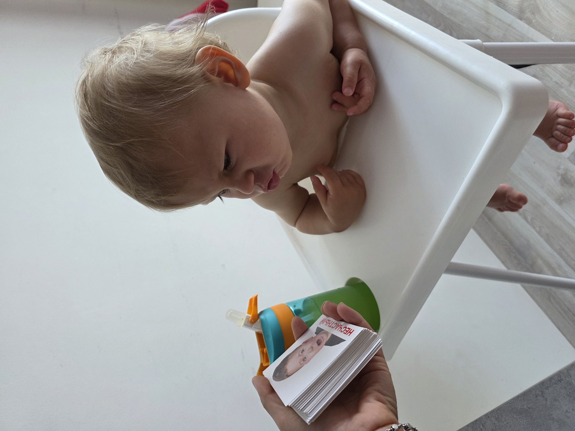 Toddler learns facial expressions through flashcards in Sochi home