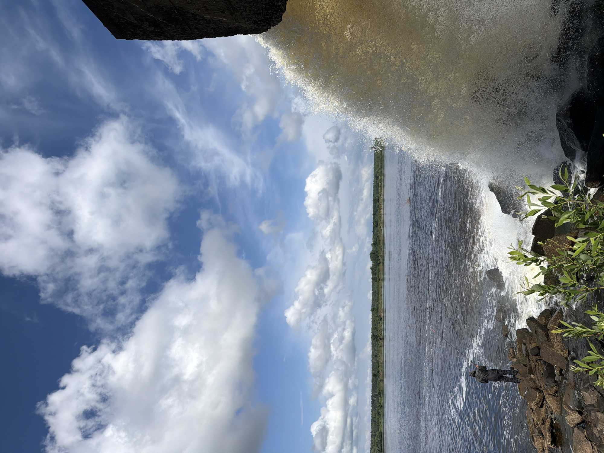 Morning scenes along Olkhovka river with wildflowers and waterfall