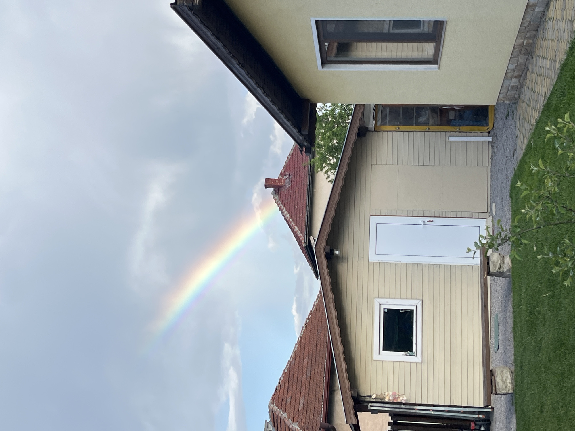 Rainbow arcs over residential neighborhood in Kostinbrod, Bulgaria