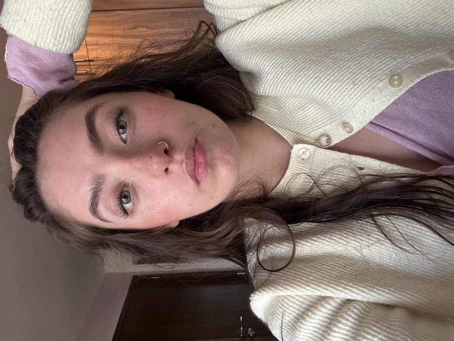 Woman documents makeup routine and outfit changes in Mexico bedroom